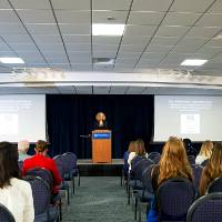 Speaker giving opening remarks to event.